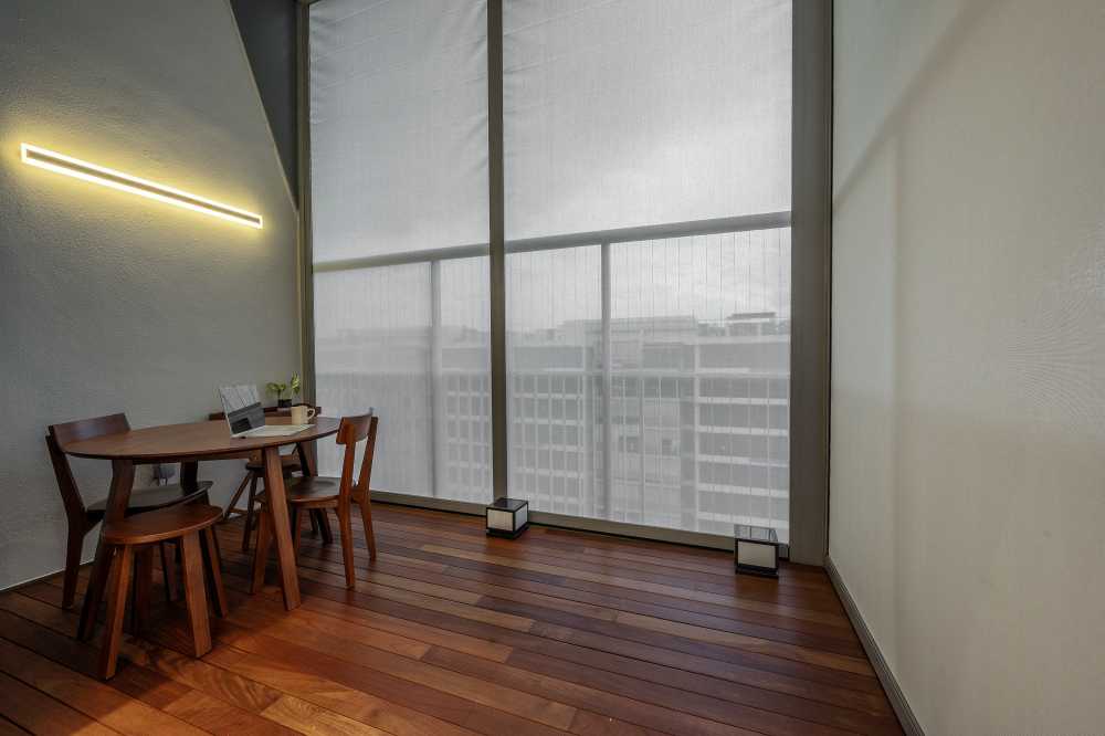 Minimalist Balcony with Wood Flooring and Window Grille
