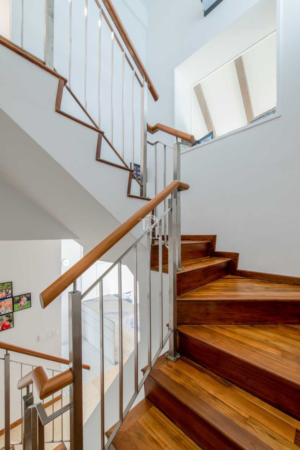 Eclectic Hallway with Wood Flooring and Staircase