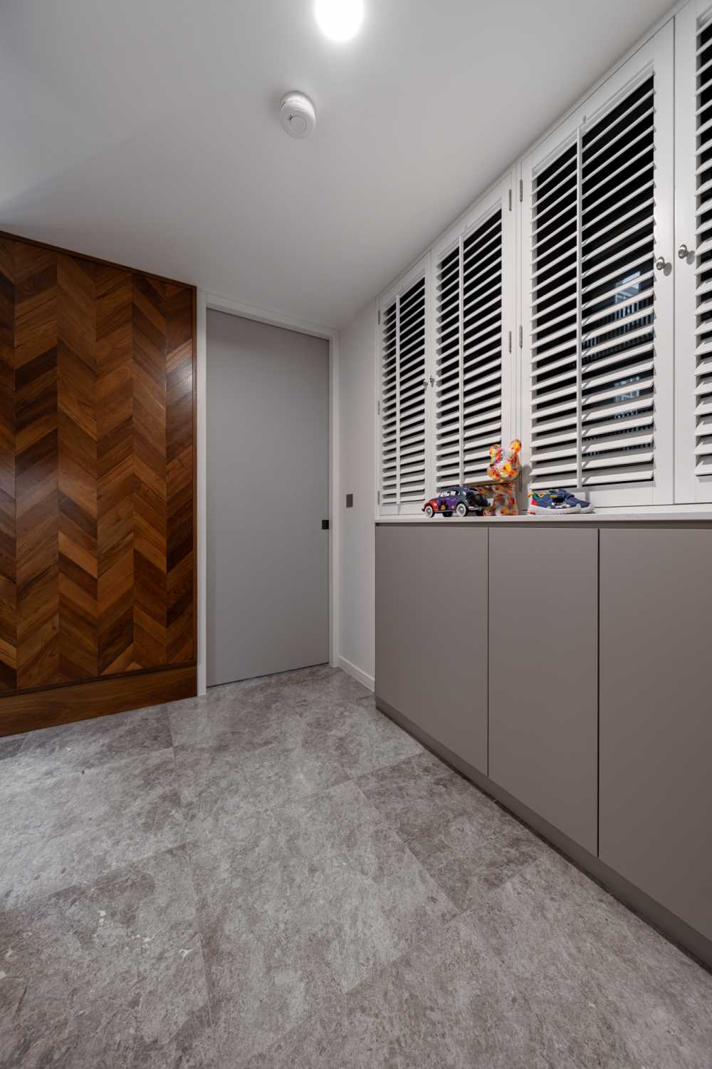 Modern Entryway with Granite Floor and Feature Wall
