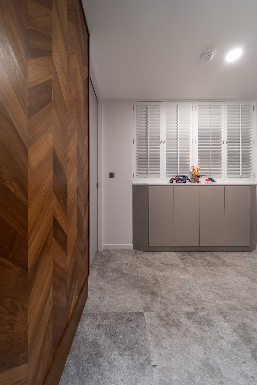 Modern Entryway with Granite Floor and Feature Wall