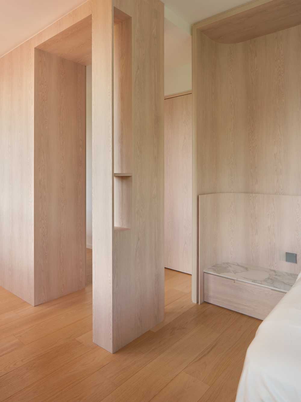 Minimalist Bedroom with Bookshelf and Parquet Floor
