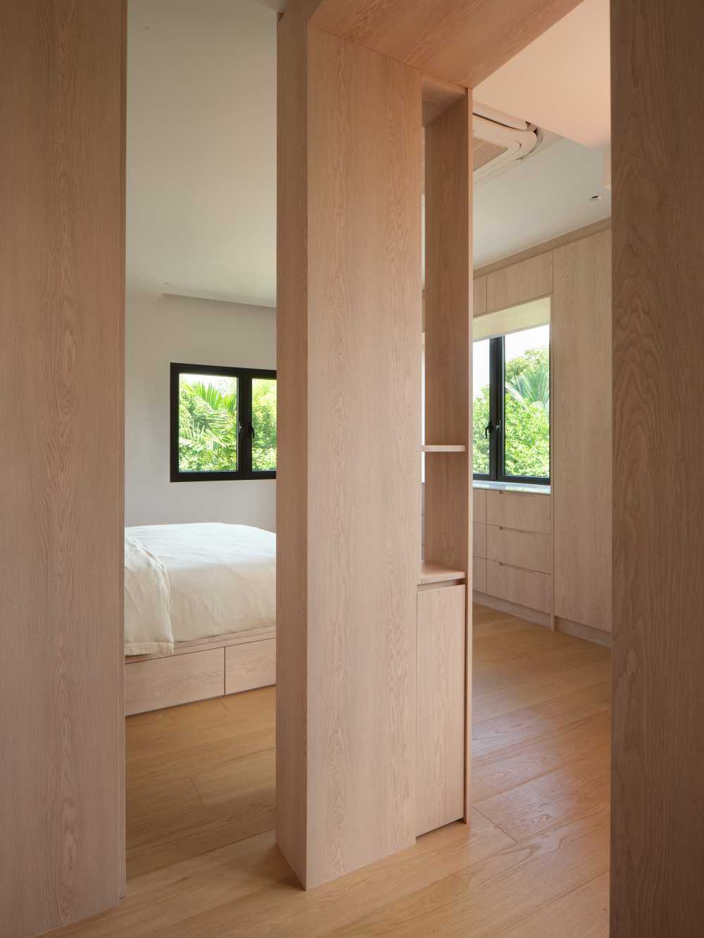 Minimalist Bedroom with Bookshelf and Wood Flooring