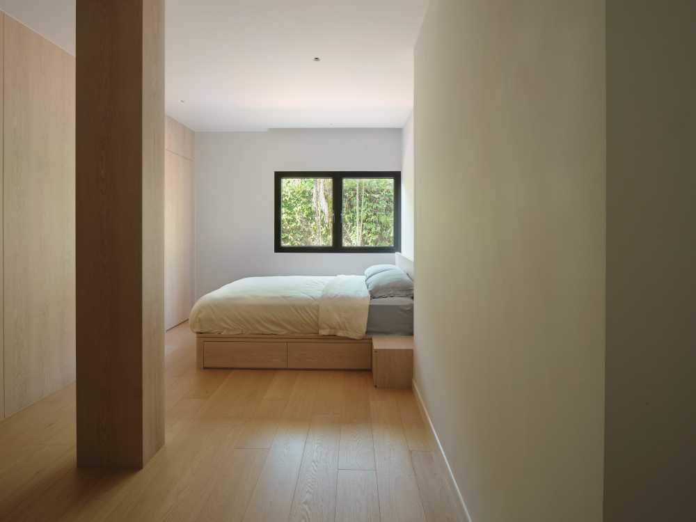 Minimalist Bedroom with Bookshelf and Wood Flooring