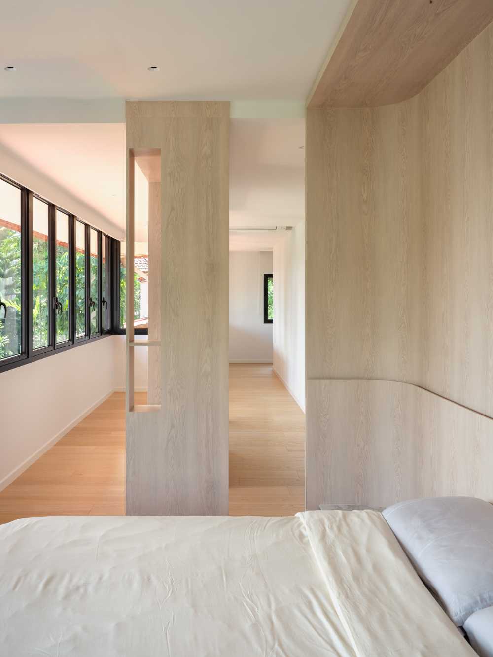Minimalist Bedroom with Wood Flooring and Cove Lighting