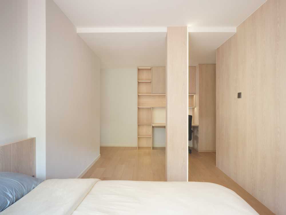 Minimalist Bedroom with Bookshelf and Parquet Floor