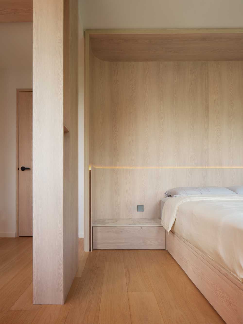 Minimalist Bedroom with Wood Flooring and Cove Lighting