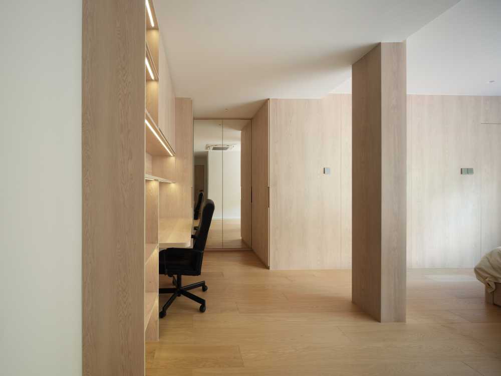 Minimalist Bedroom with Bookshelf and Wood Flooring