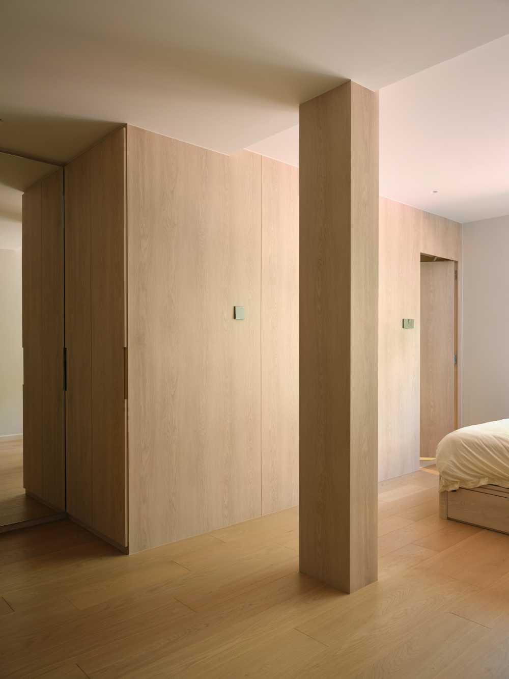 Minimalist Bedroom with Wood Flooring and Drop Light