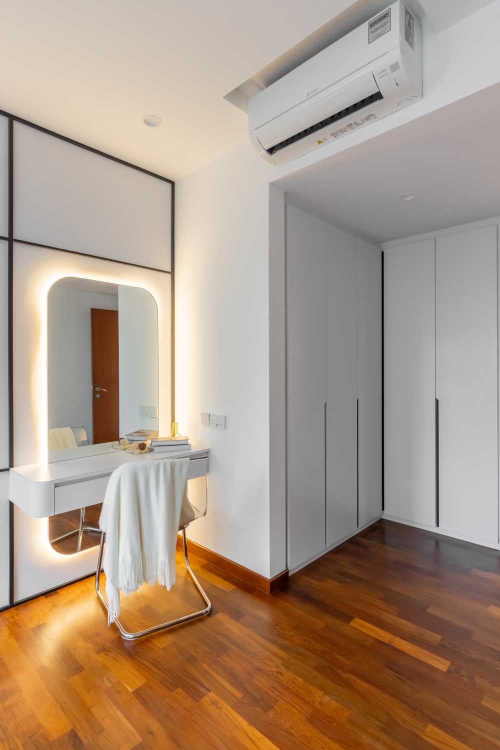 Minimalist Bedroom with Wood Flooring and Wardrobe