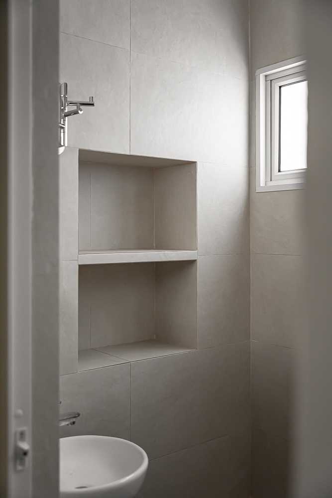 Scandinavian Bathroom with Homogeneous Tiles and Mirror