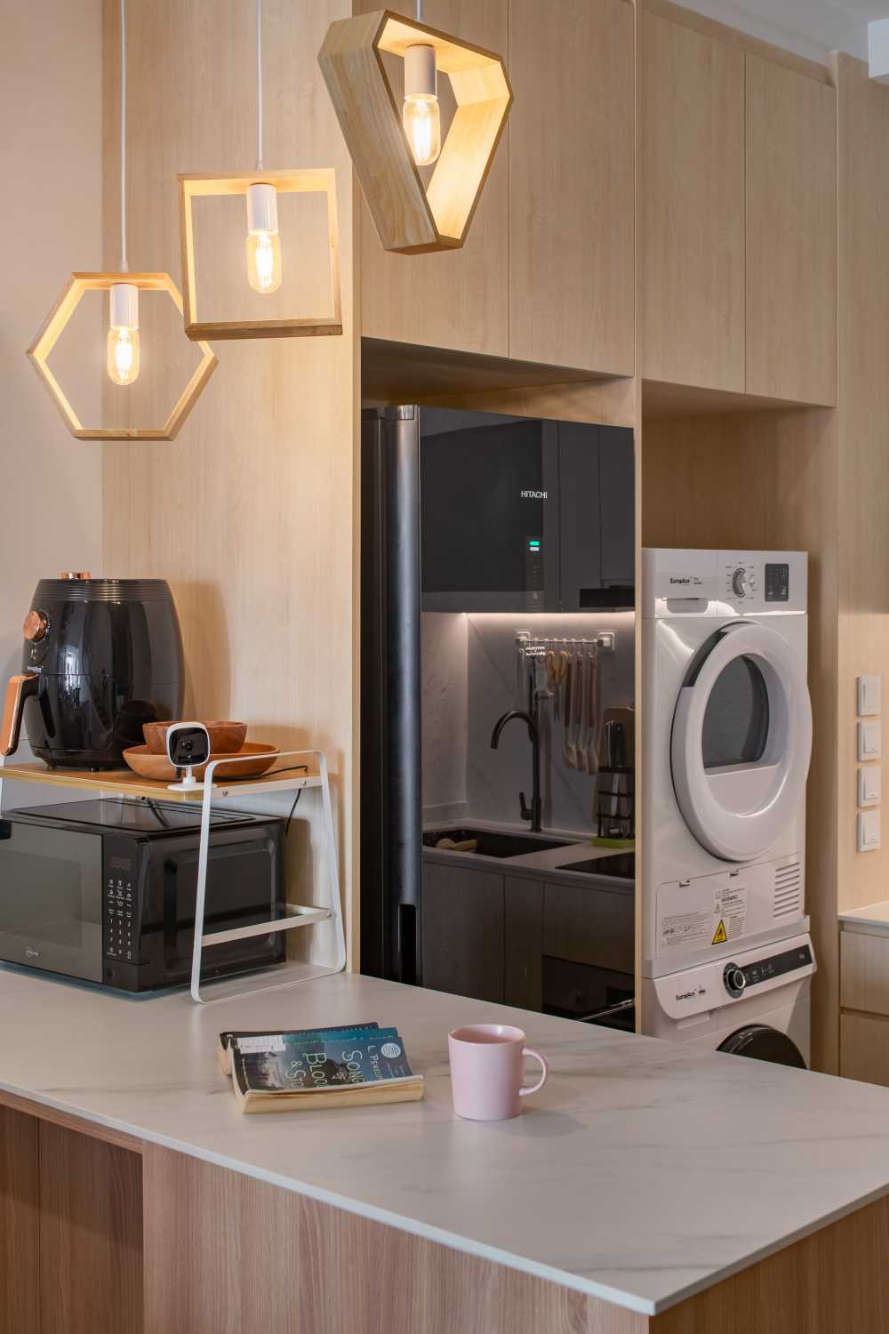 Scandinavian Dining Room with Drop Light and Laundry Area