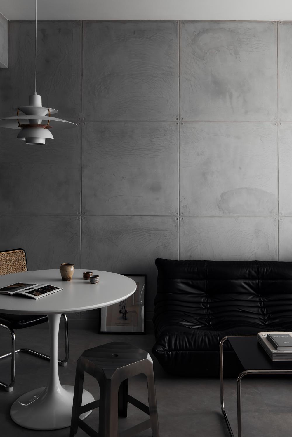 Industrial Living Room with Cement Floor and Feature Wall