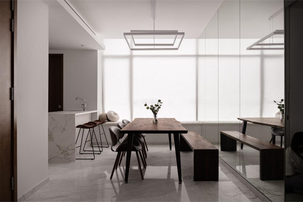 Minimalist Dining Room with Mirror and Open Kitchen