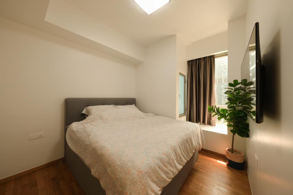 Modern Bedroom with Wood Flooring and Ceiling Light