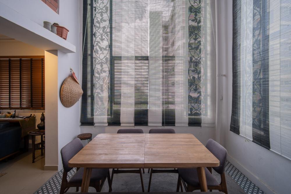 Industrial Dining Room with Roller Blinds and Dining Table