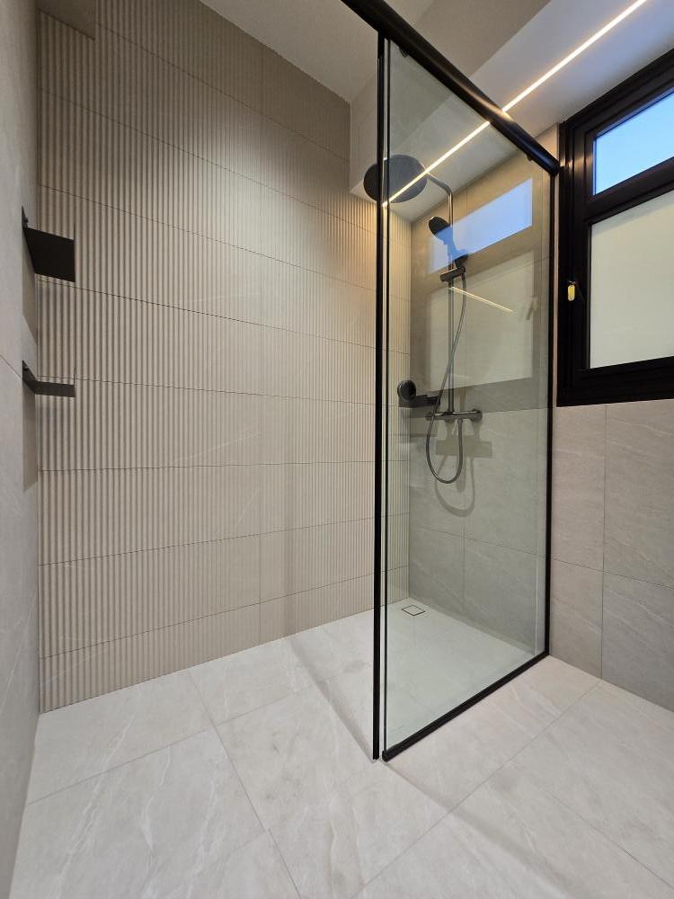 Scandinavian Bathroom with Shower Screen and Showers