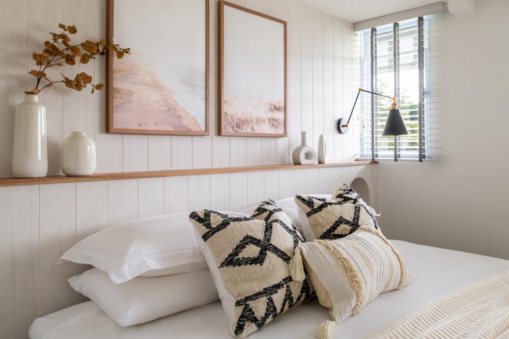 Transitional Bedroom with Feature Wall and Paintings