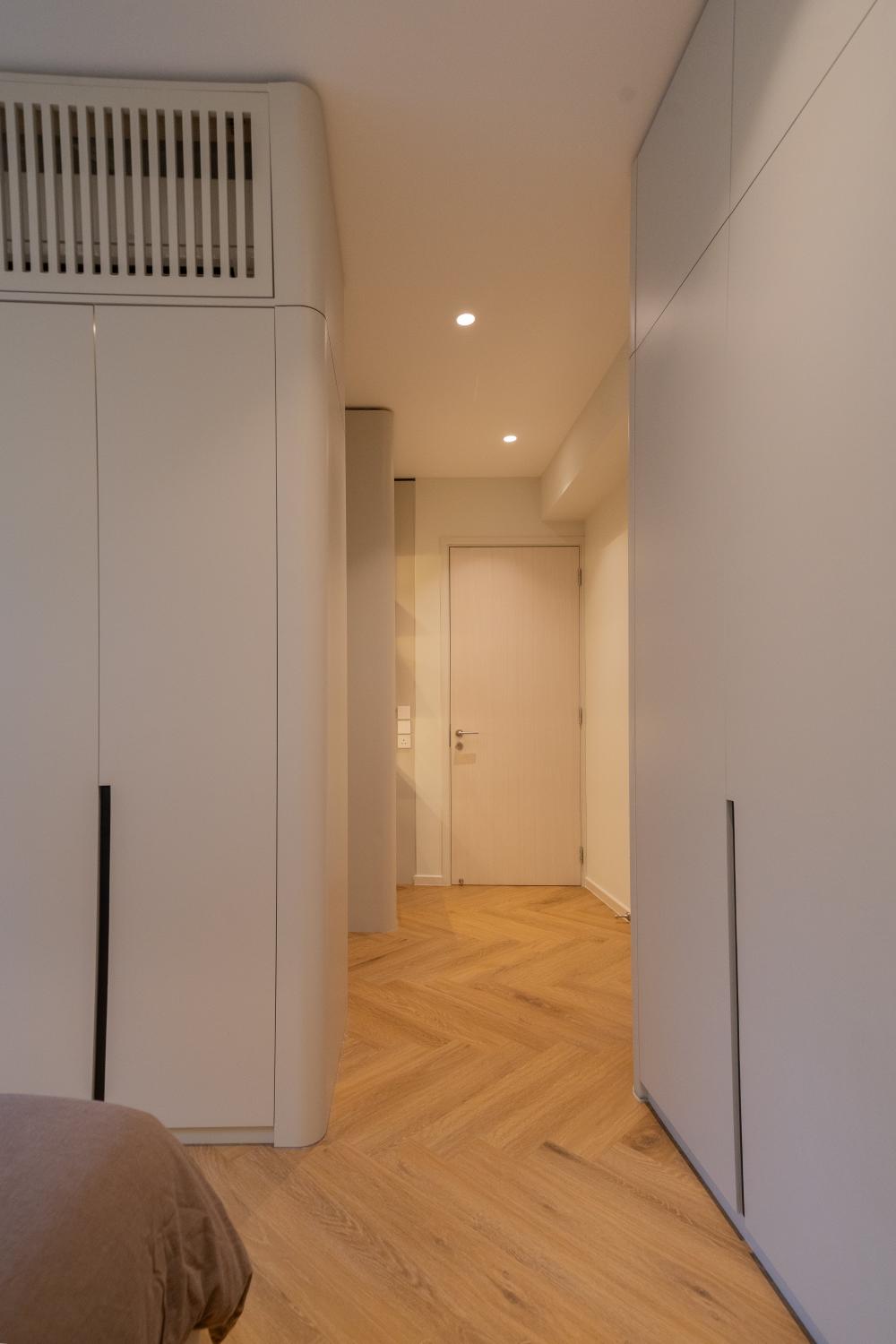 Minimalist Bedroom with Bookshelf and Parquet Floor