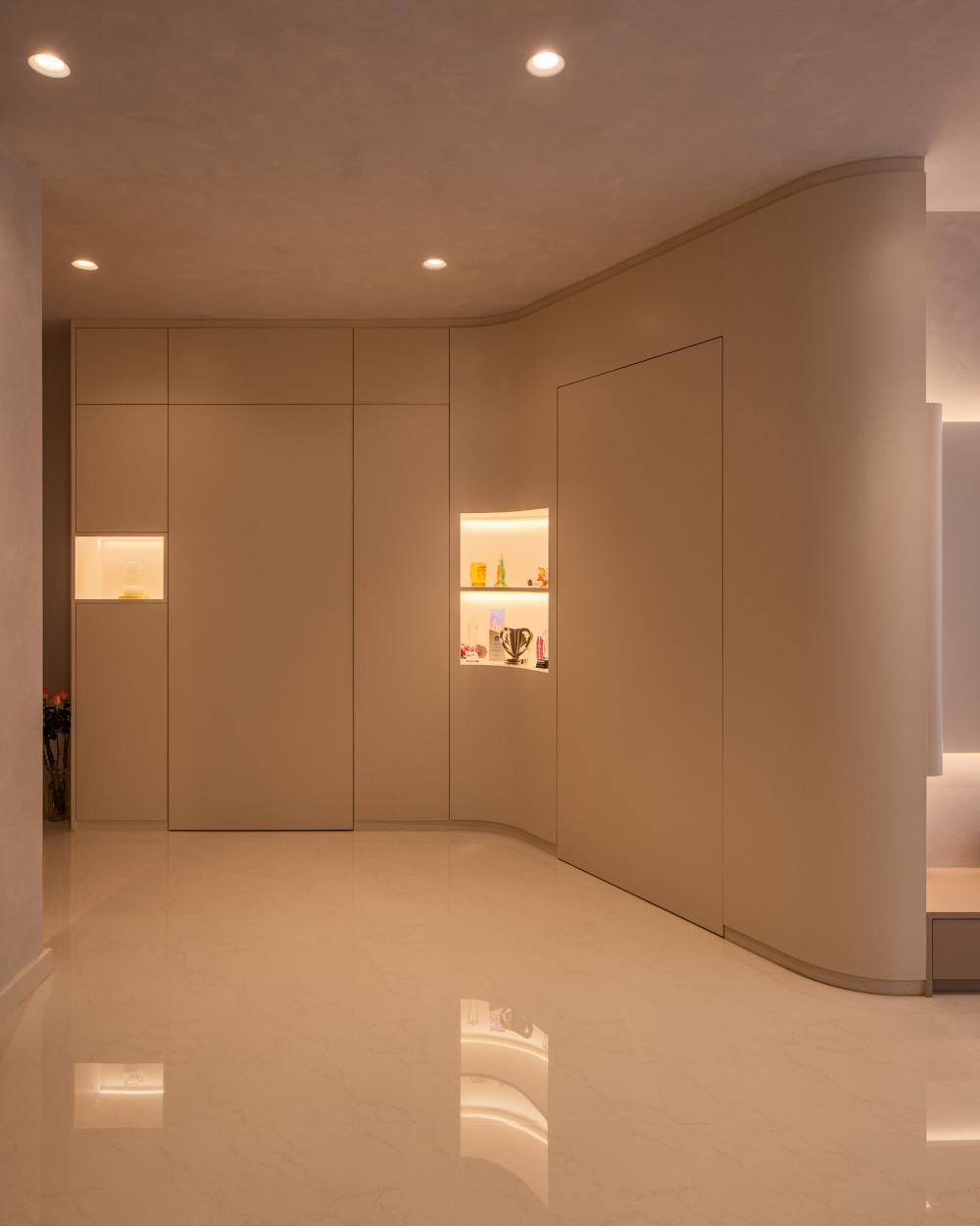 Minimalist Foyer with Cove Lighting and Downlights