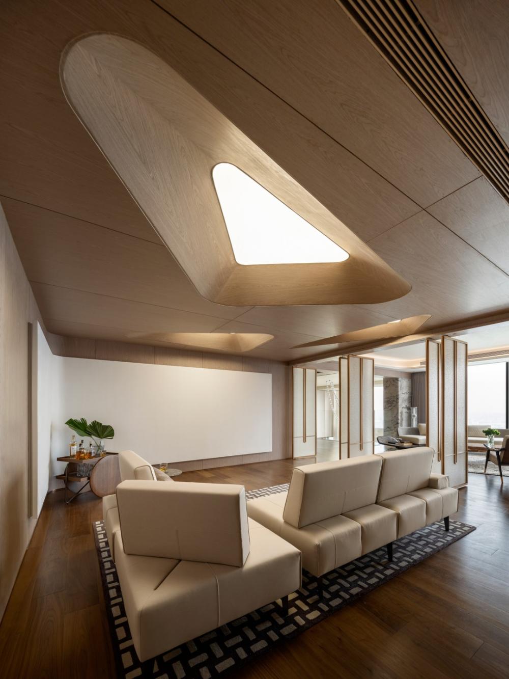 Contemporary Home Theatre with Wood Flooring and Feature Wall