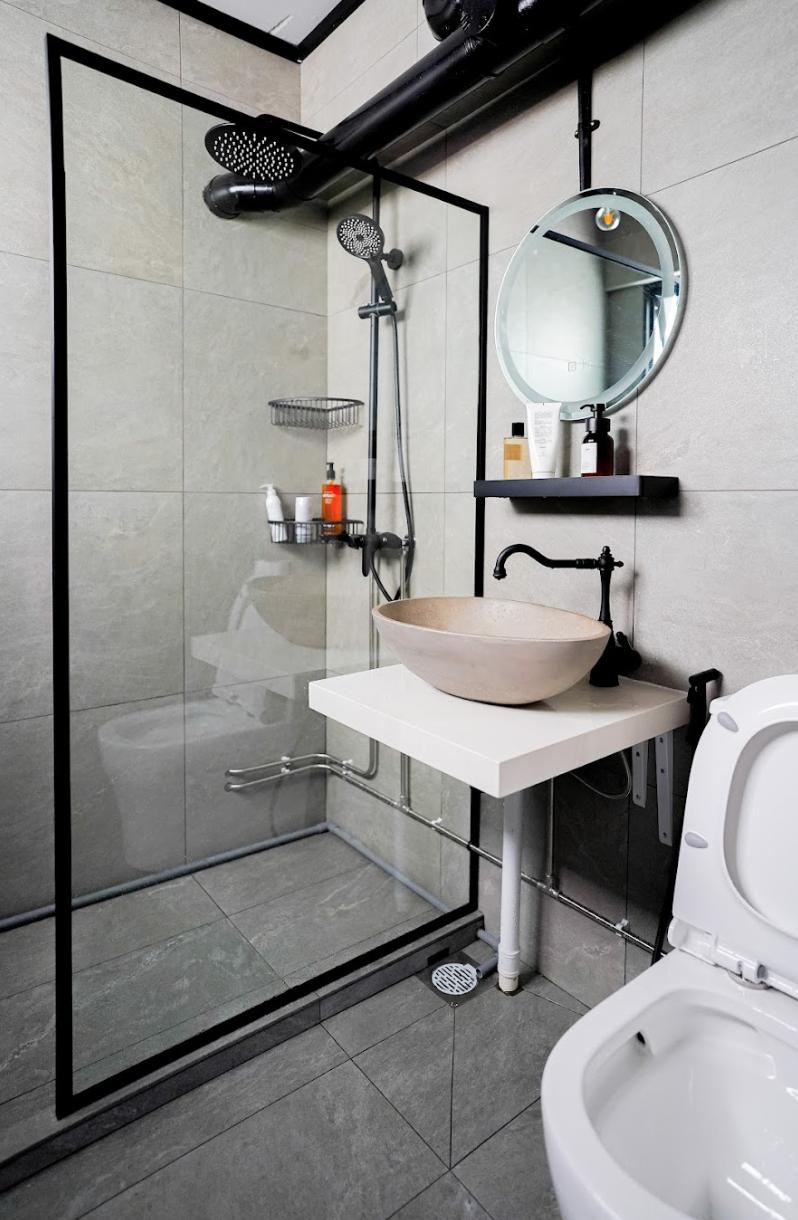 Industrial Bathroom with Homogeneous Tiles and Mirror