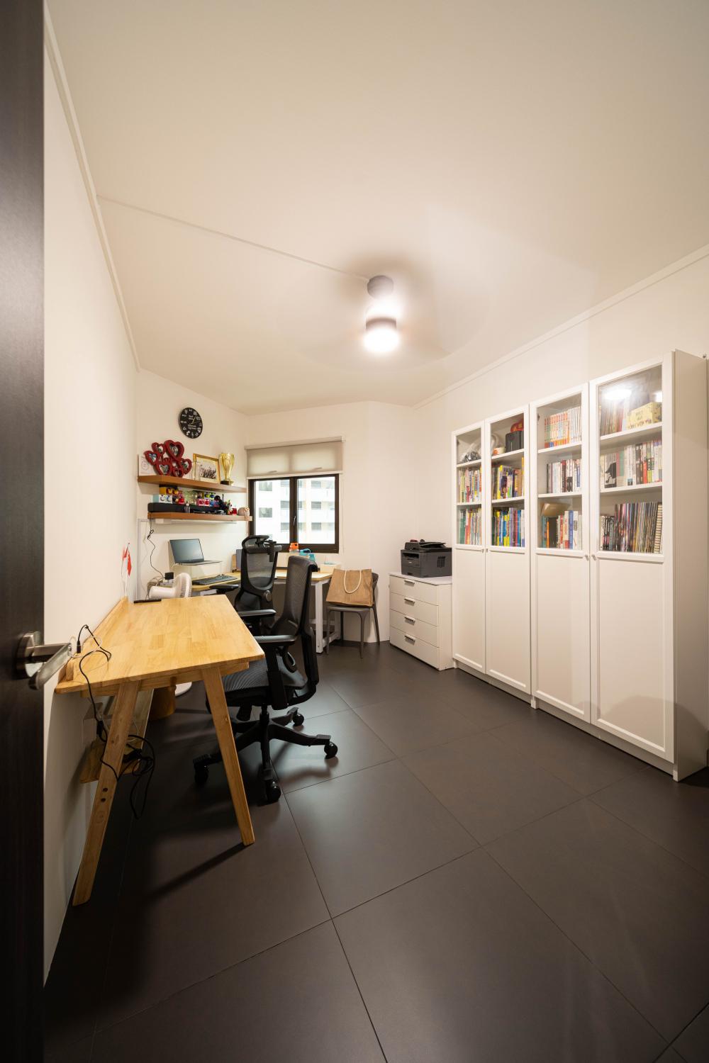 Transitional Home Office with Bookshelf and Desk Chairs