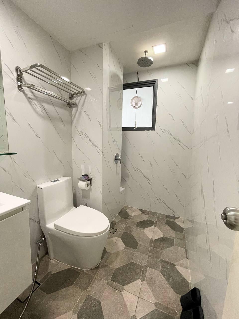 Asian Bathroom with Homogeneous Tiles and Rainshower