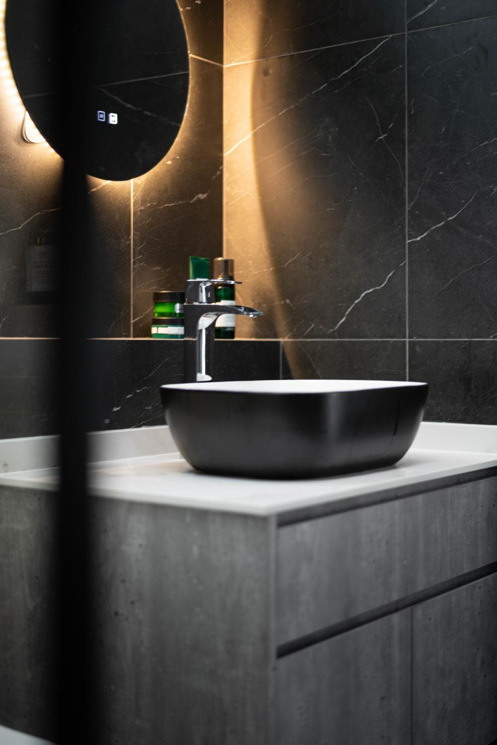 Industrial Bathroom with Homogeneous Tiles and Vanity Counter
