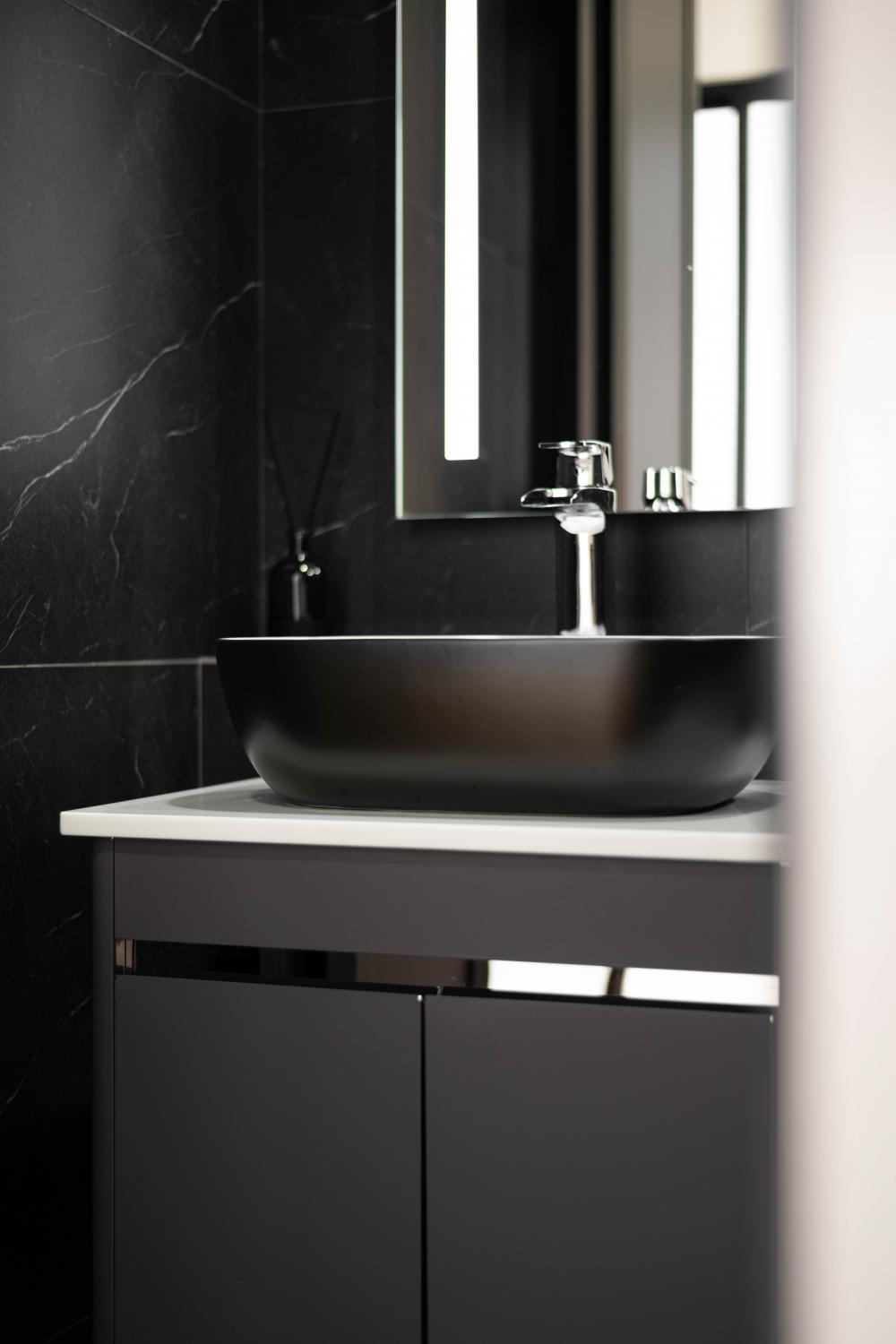 Industrial Bathroom with Homogeneous Tiles and Mirror