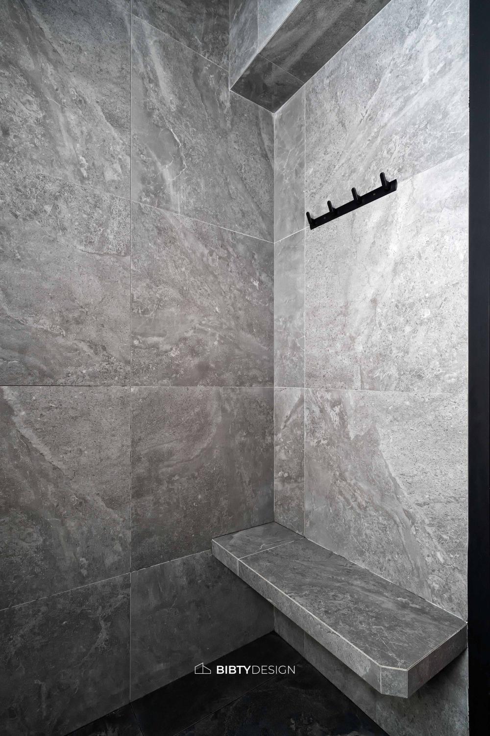 Industrial Bathroom with Homogeneous Tiles and Mirror