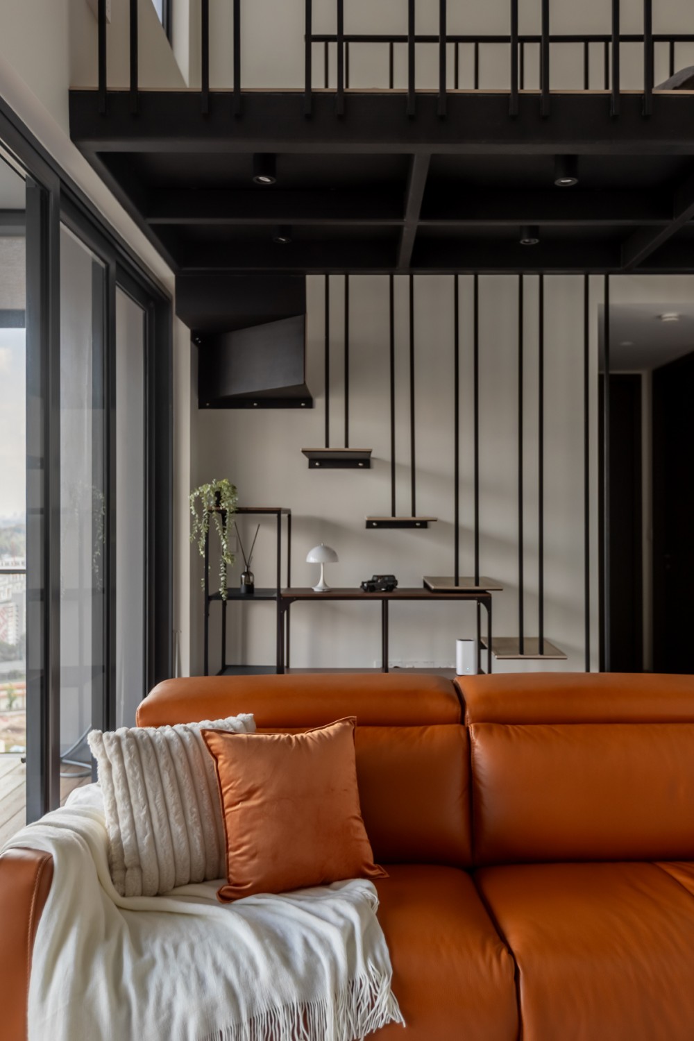 Modern Living Room with Staircase and Glass Door