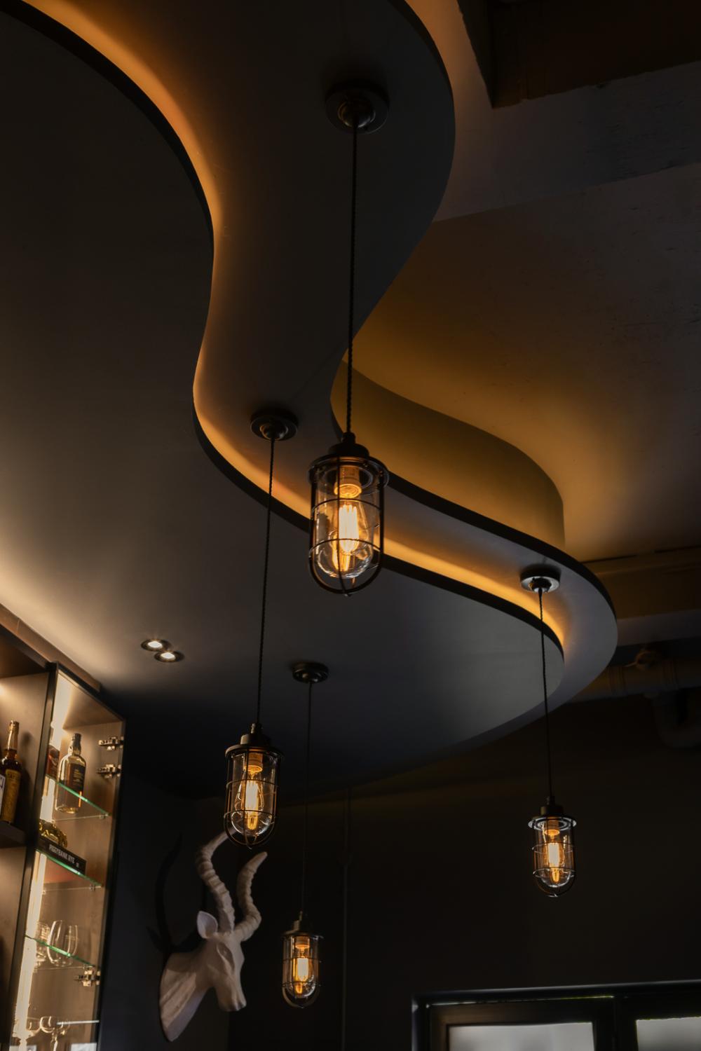 Industrial Home Bar with Drop Ceiling and Lighting