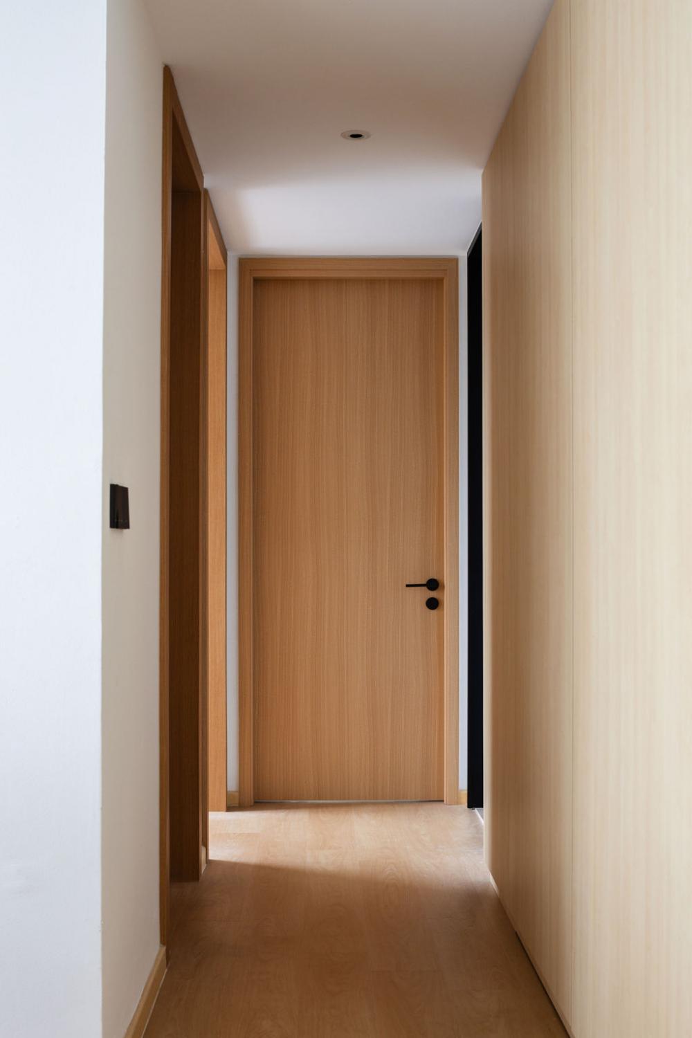 Minimalist Hallway with Wood Flooring and Feature Wall