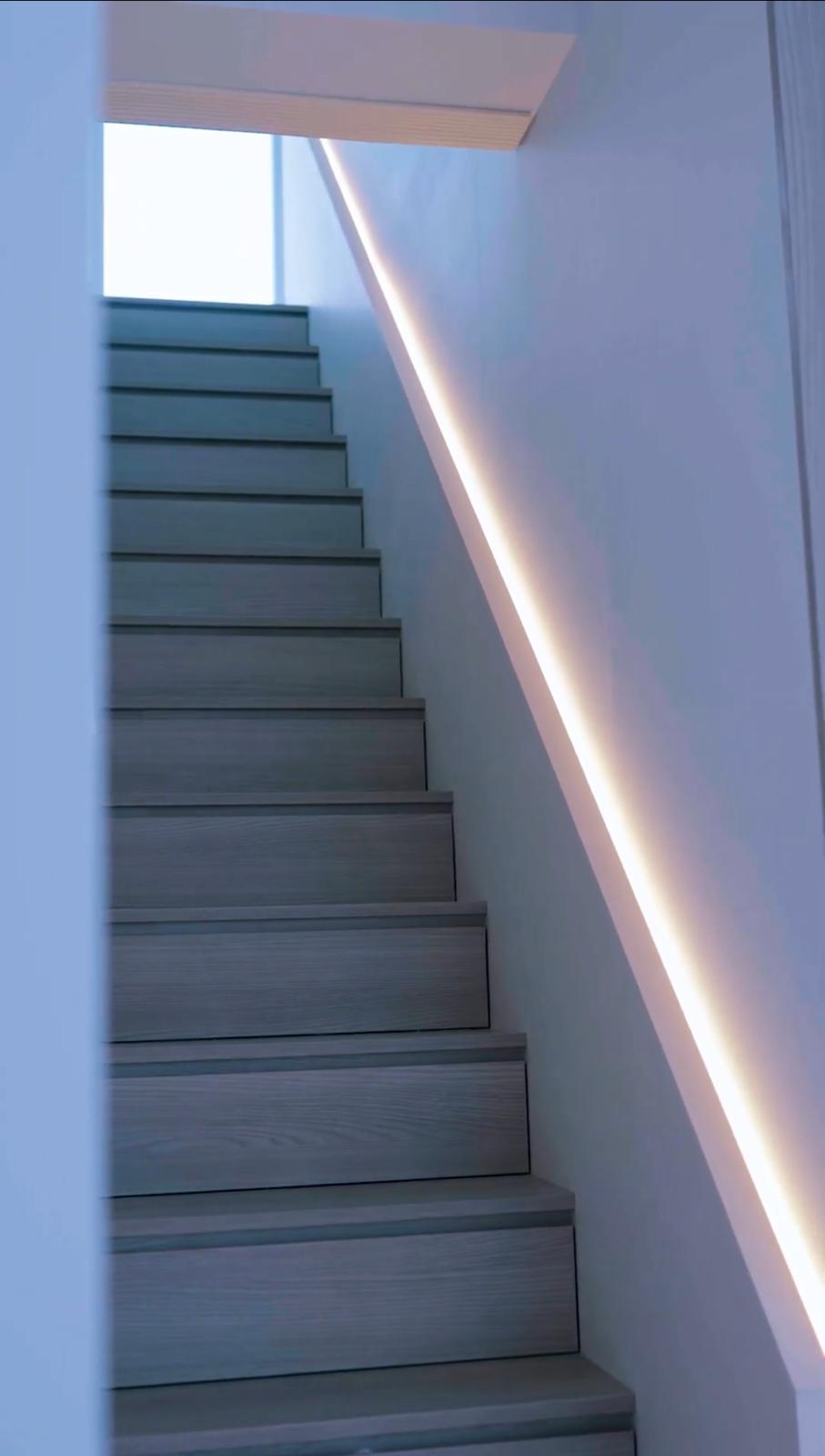 Minimalist Entryway with Staircase and Storage Cabinets