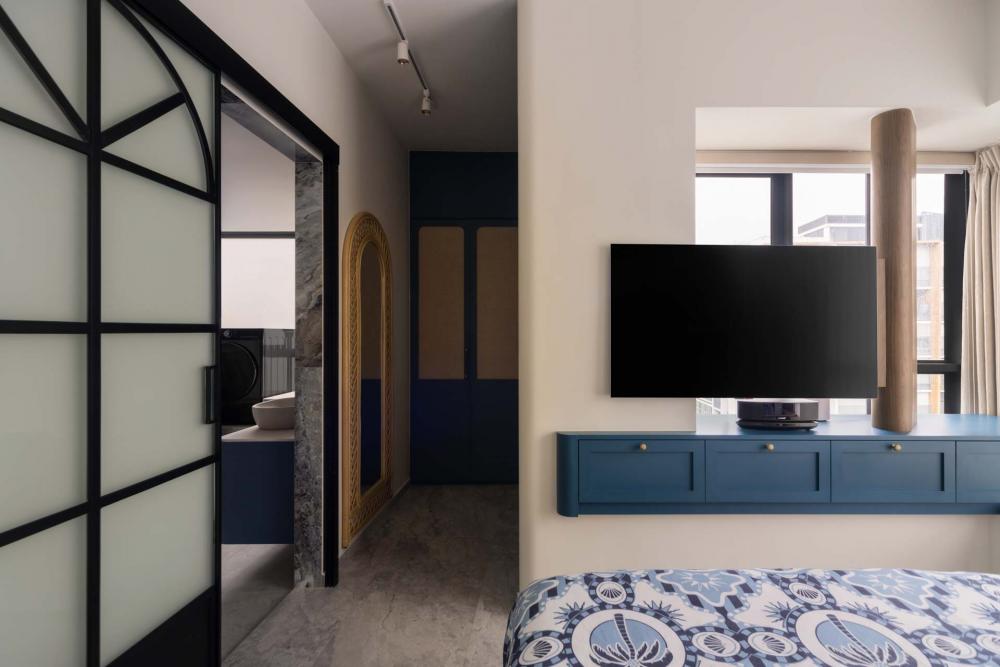 Eclectic Bedroom with TV Console and Glass Door