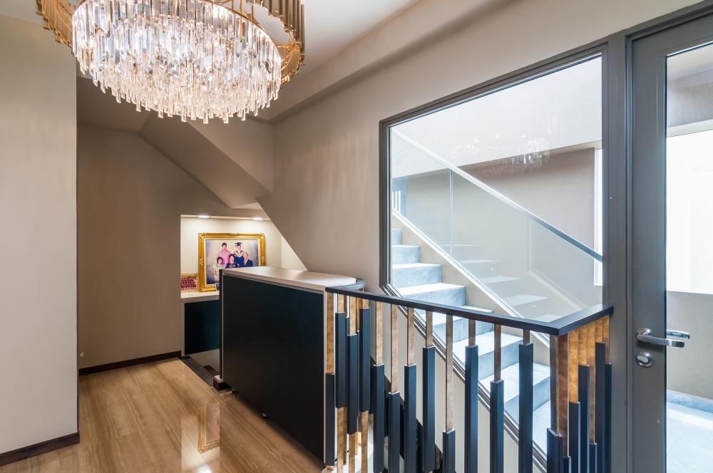 Contemporary Hallway with Homogeneous Tiles and Chandelier
