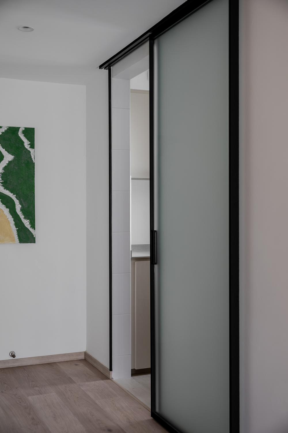 Transitional Foyer with Homogeneous Tiles and Drop Light
