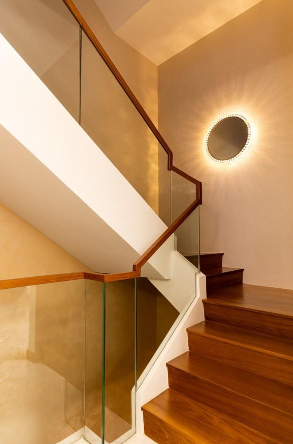 Transitional Hallway with Parquet Floor and Feature Wall