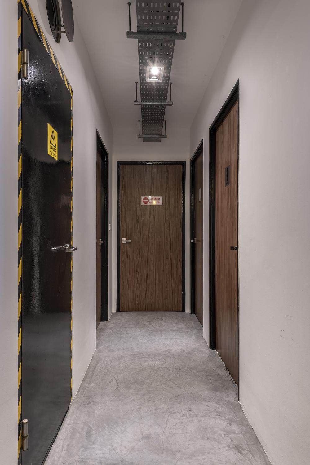 Industrial Hallway with Bookshelf and Artwork