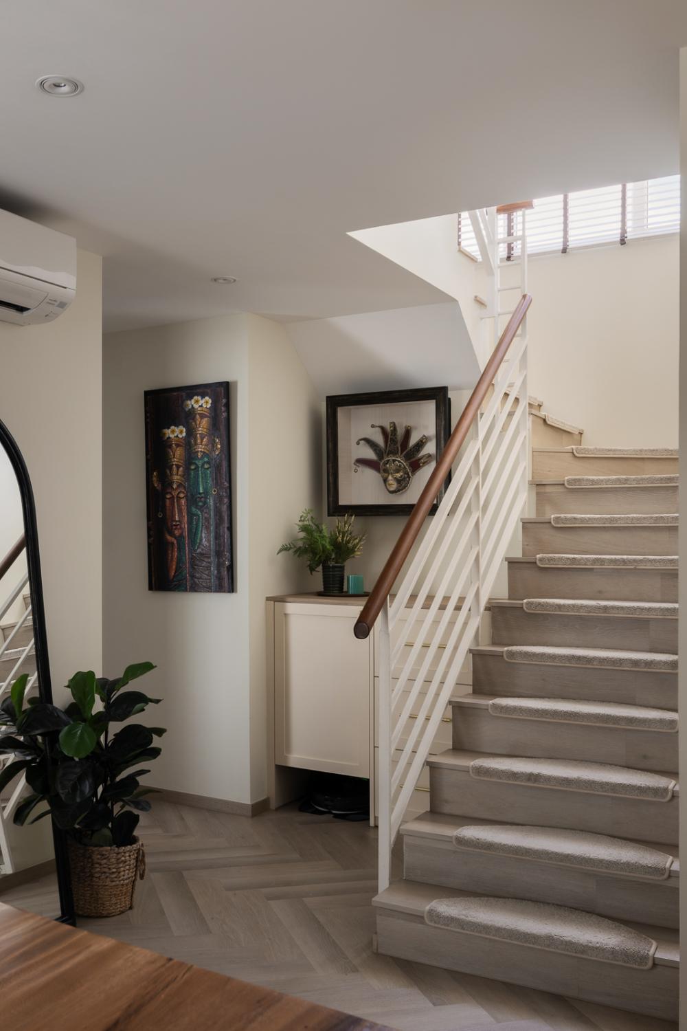 Eclectic Hallway with Herringbone Tiling and Staircase