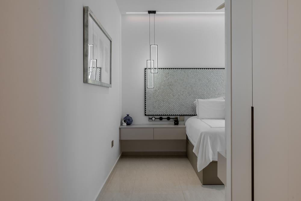 Modern Bedroom with Homogeneous Tiles and Cove Lighting