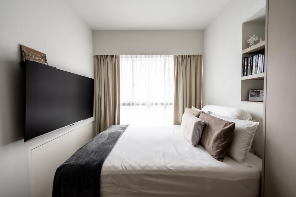 Minimalist Bedroom with Bookshelf and Homogeneous Tiles