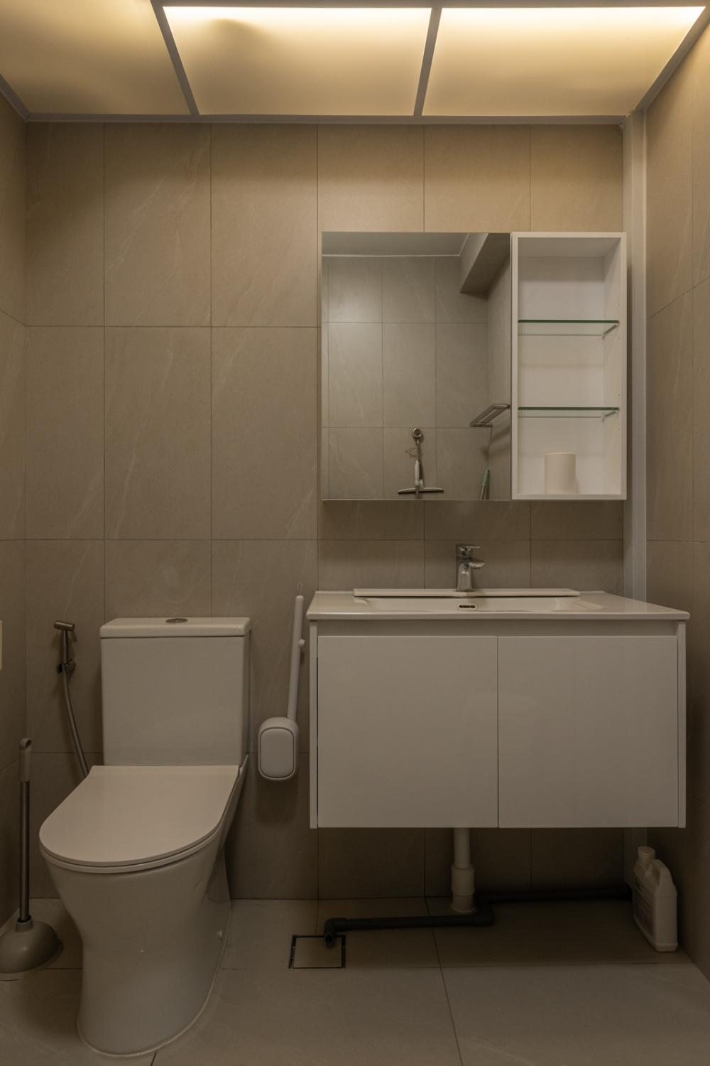 Minimalist Bathroom with Homogeneous Tiles and Bathroom Storage