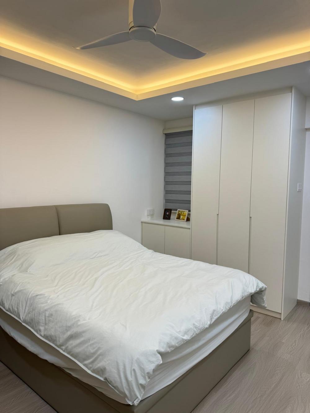 Minimalist Bedroom with Wood Flooring and Ceiling Light