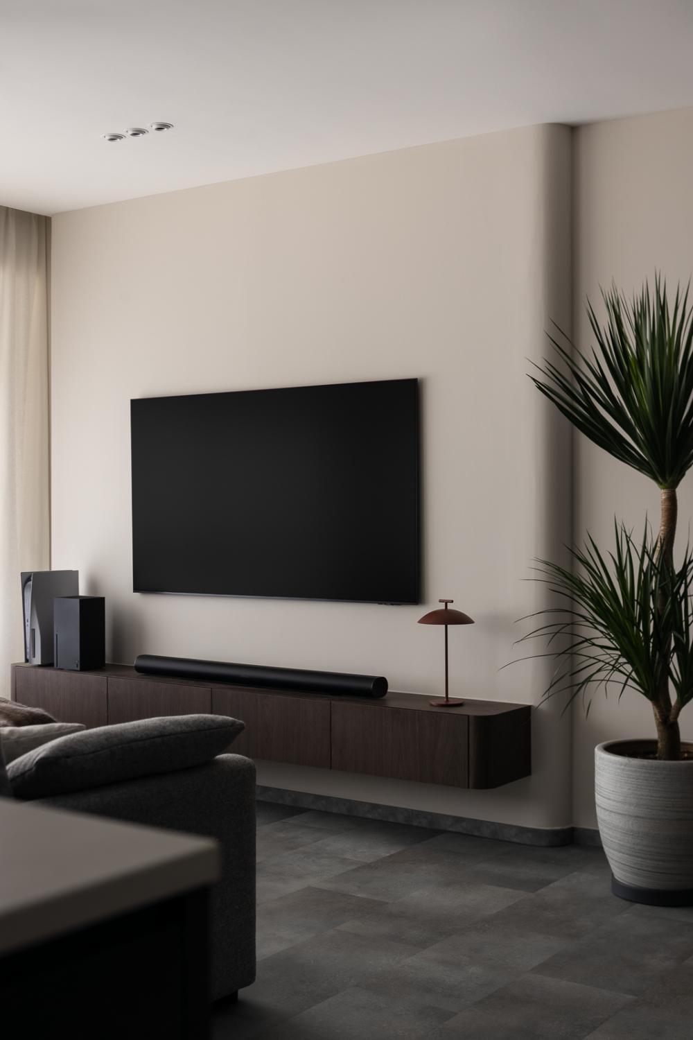 Minimalist Living Room with Homogeneous Tiles and TV Console