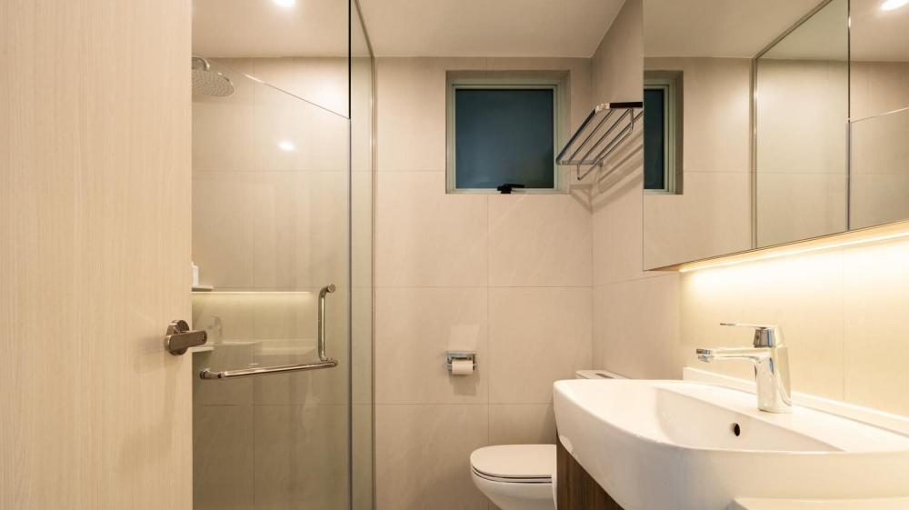 Modern Bedroom with Homogeneous Tiles and Shower Screen