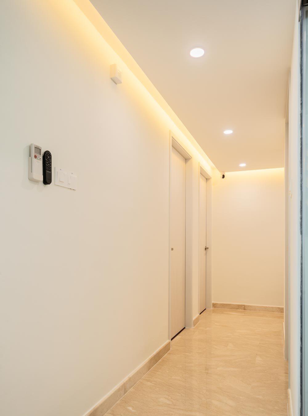 Modern Hallway with Marble Floor and Cove Lighting