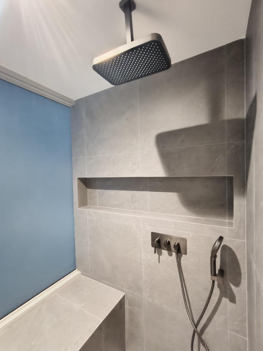 Scandinavian Bathroom with Homogeneous Tiles and Rainshower