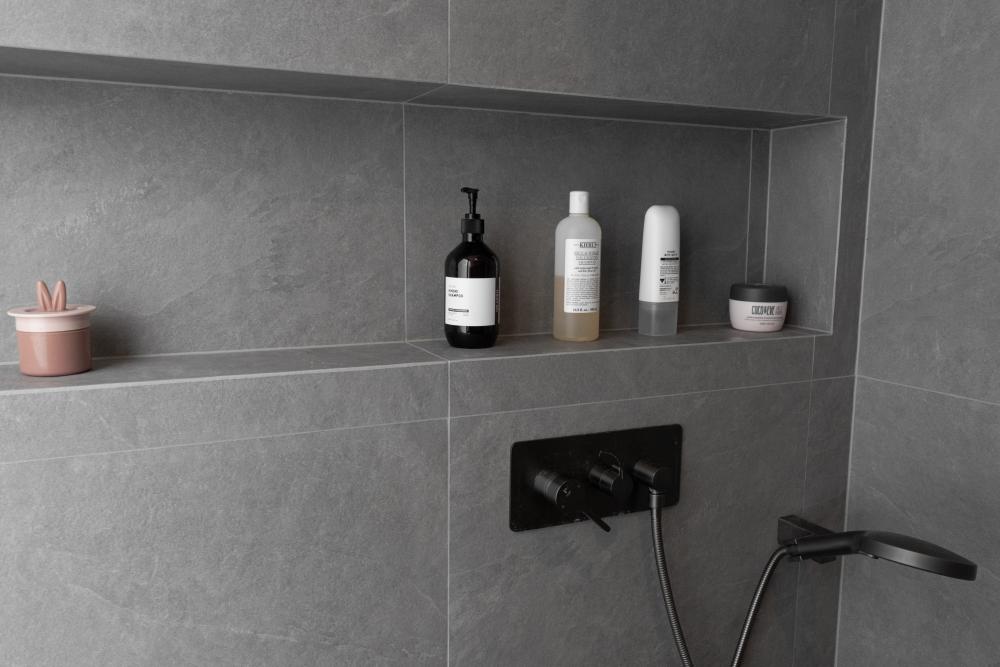 Scandinavian Bathroom with Homogeneous Tiles and Rainshower