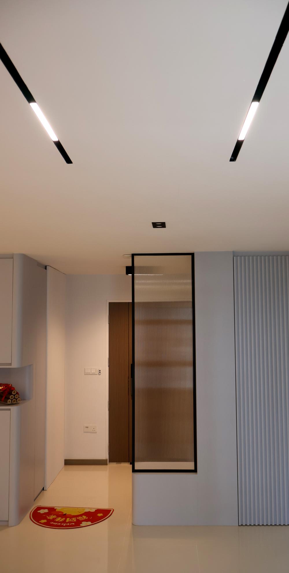 Minimalist Hallway with Homogeneous Tiles and Cove Lighting